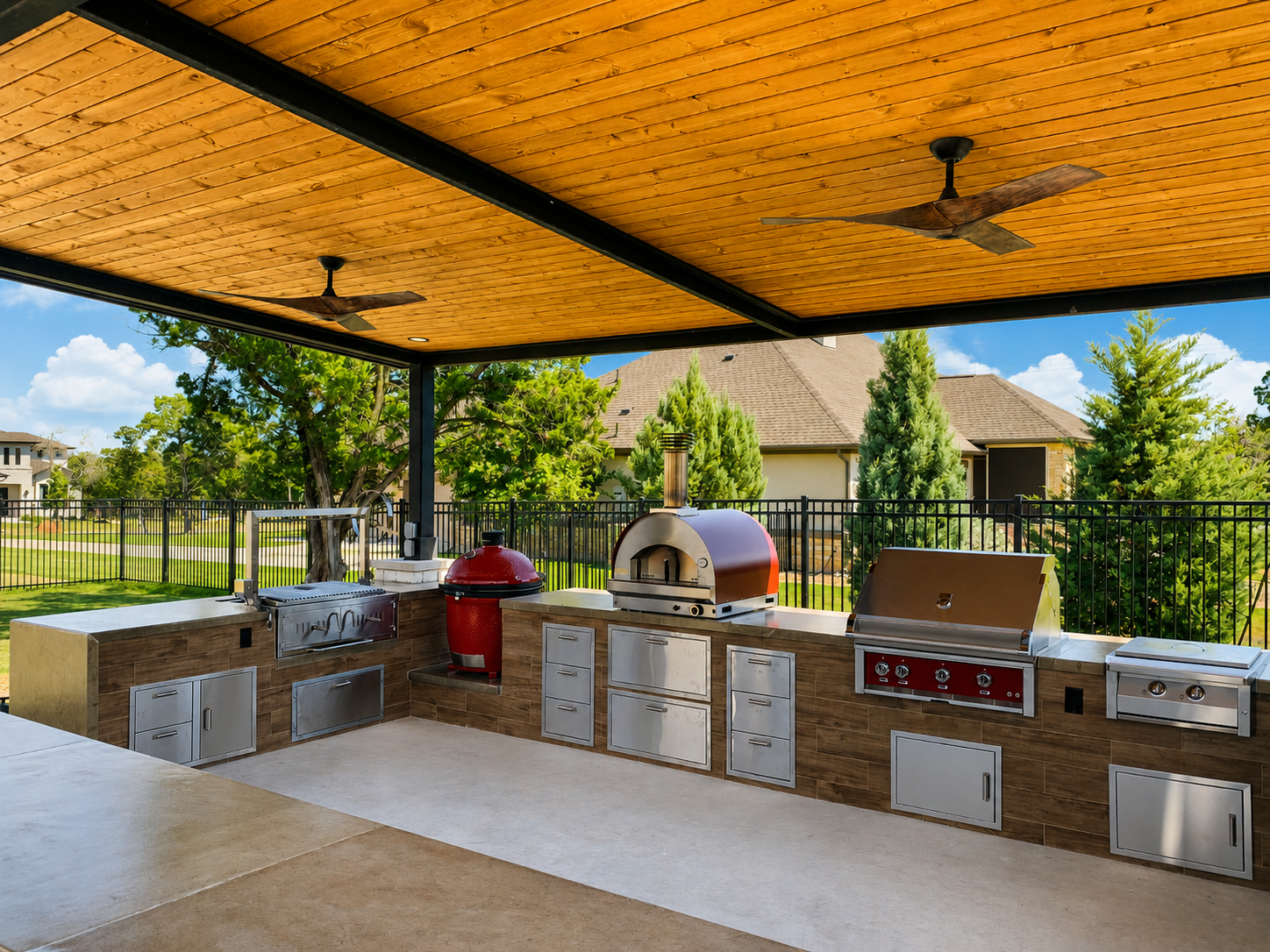 Outdoor kitchen with wood ceiling by Paul's Lawn & Landscape, Austin